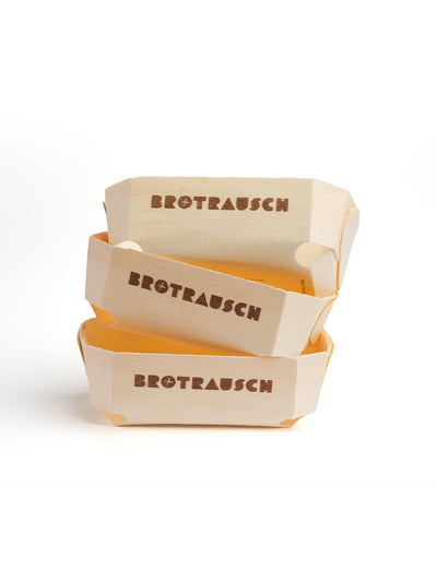 Drei kurze Holzbackformen mit Brotrausch Logo, gestapelt